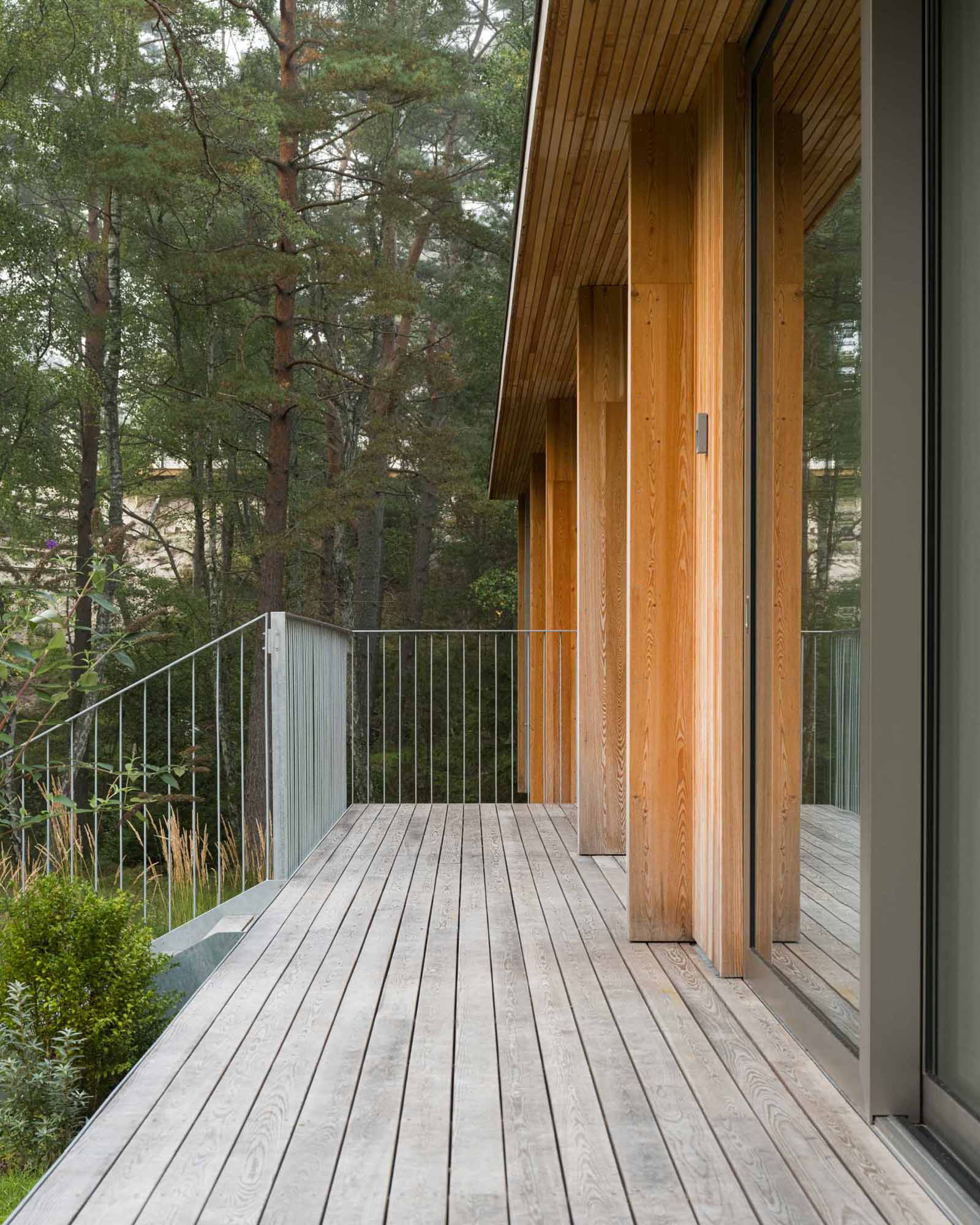 An elevated summer home clad in larch wood.