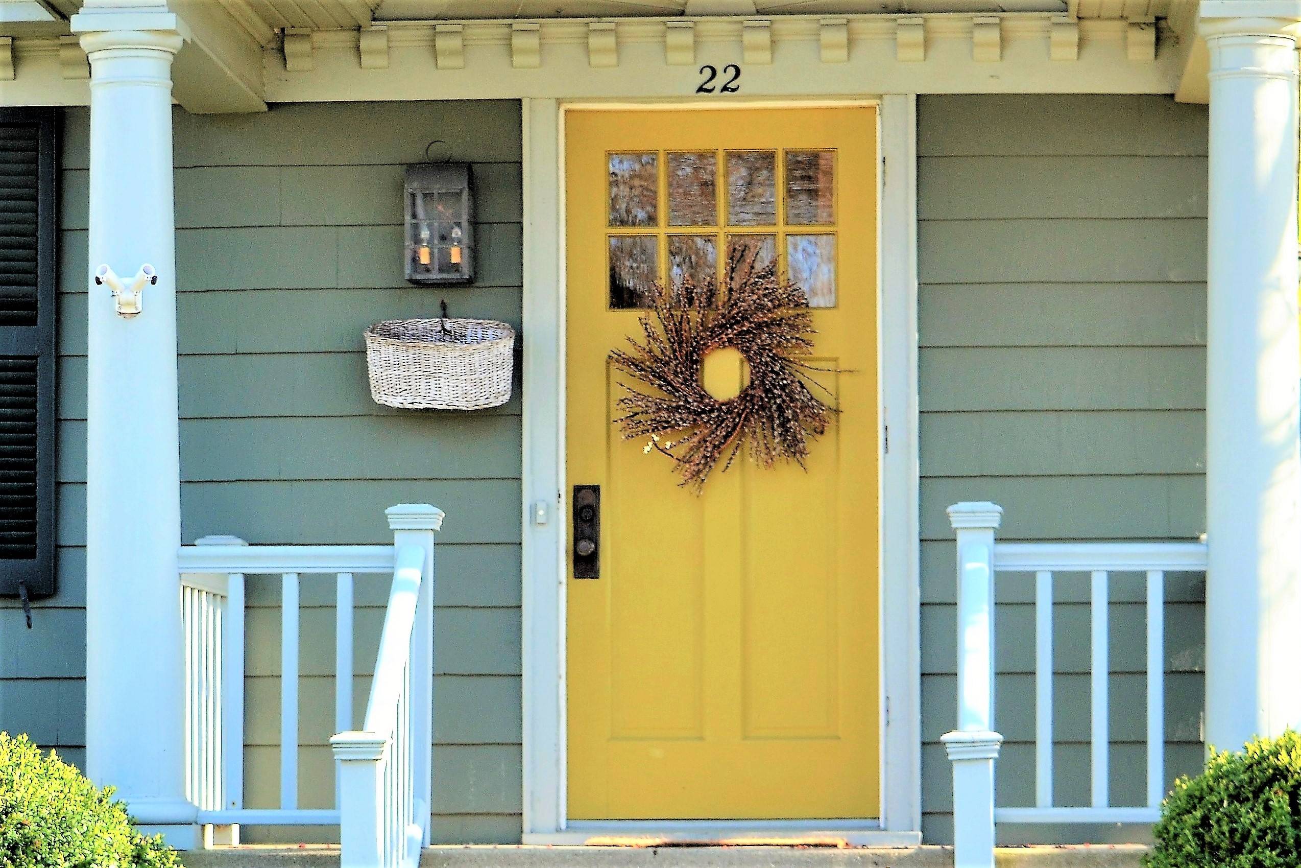 The front of a house with a yellow door.